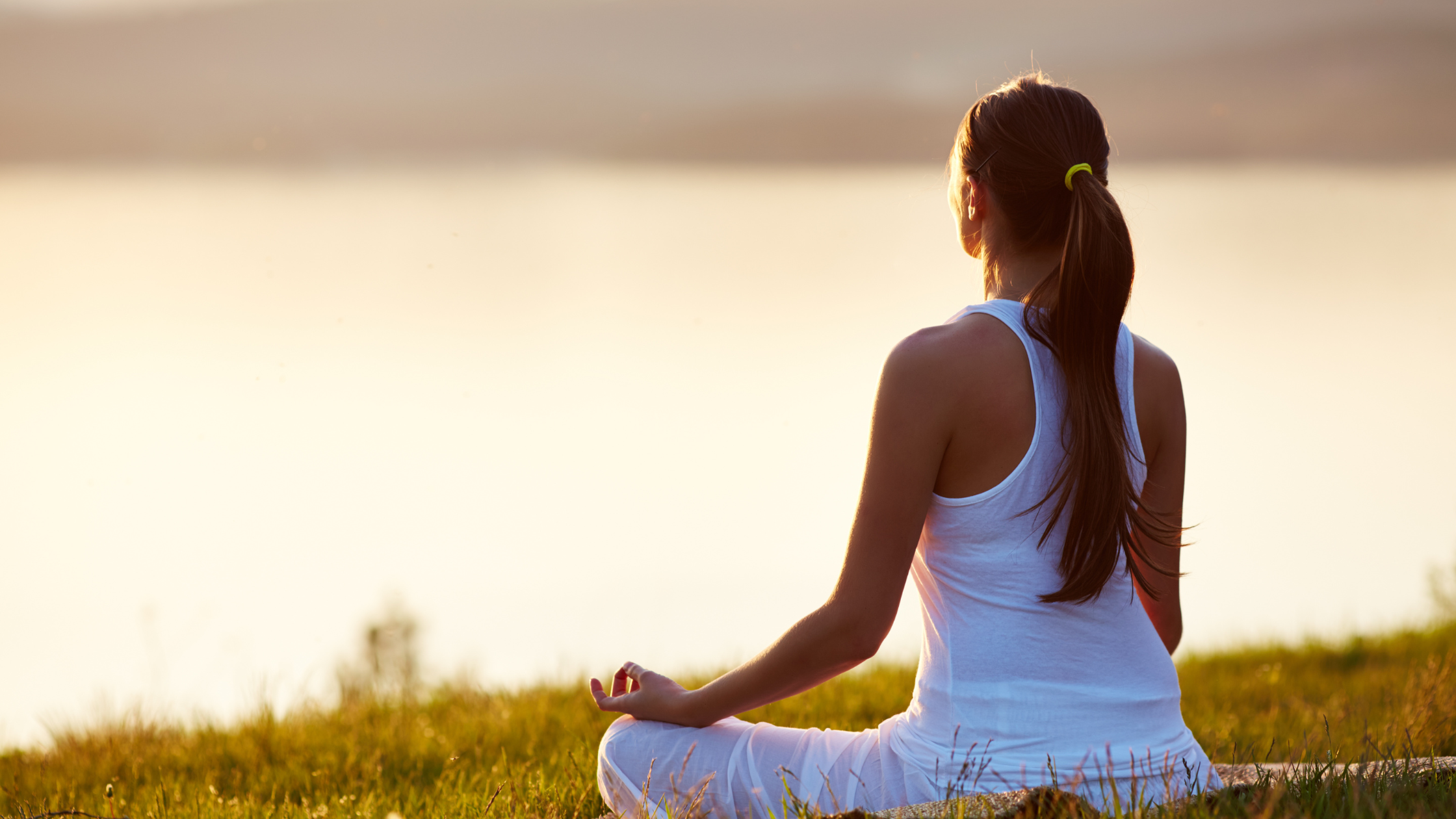 woman sitiing in nature meditating