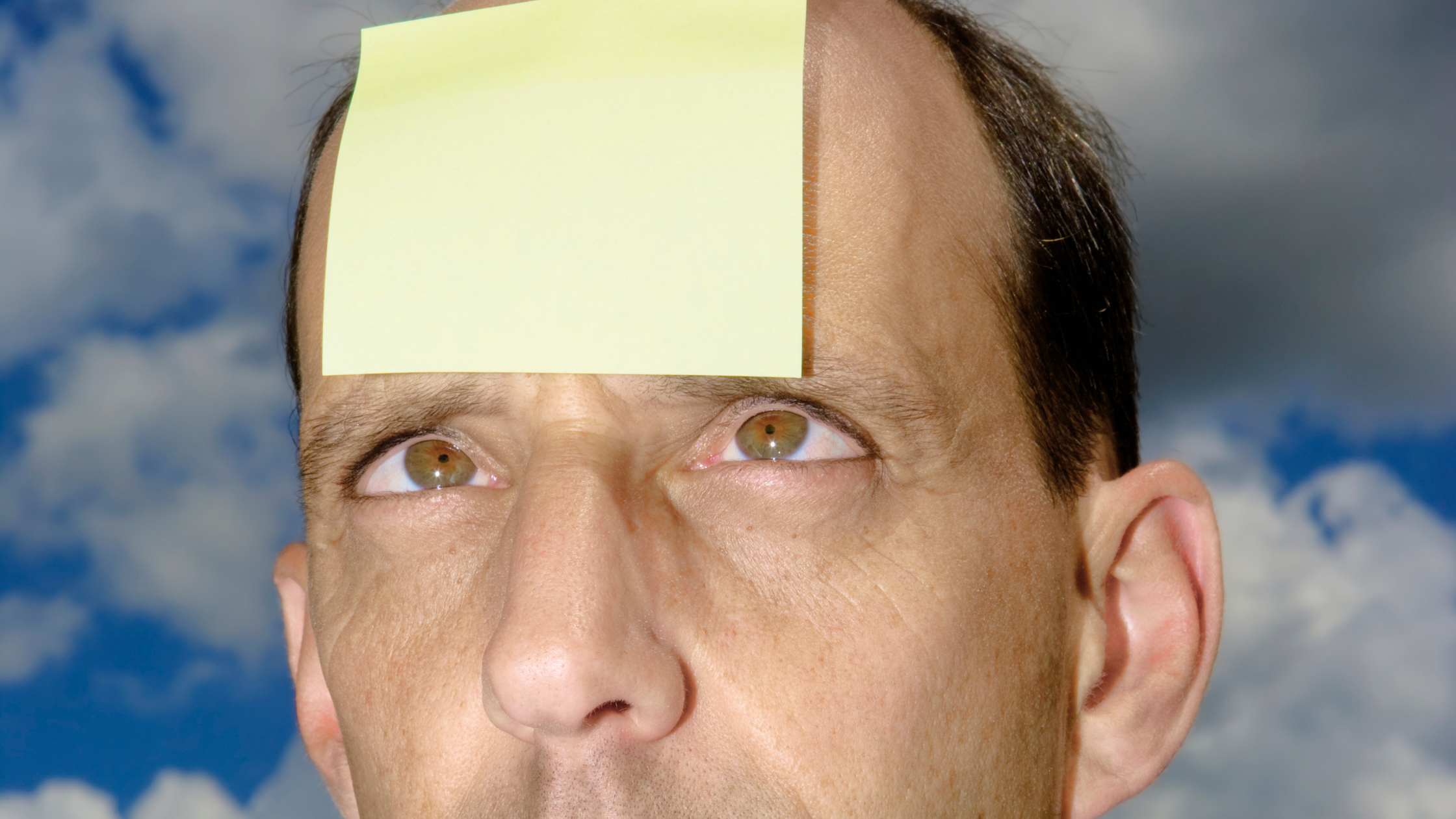 Man with yellow sticky note on forehead