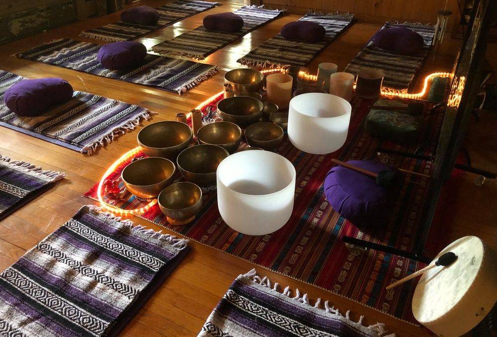 singing bowls and blankets laid out for a sound healing