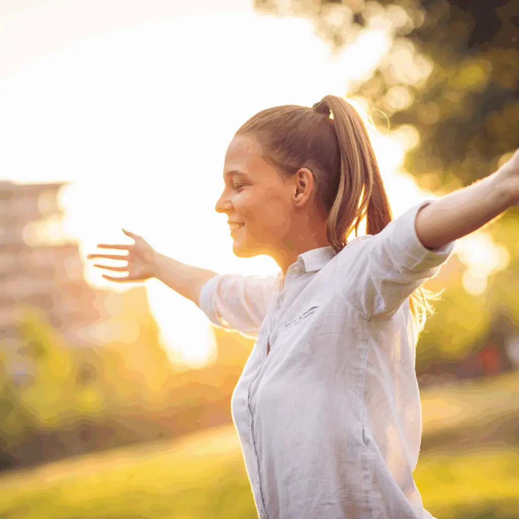 woman embracing the sunshine with outstretched arms