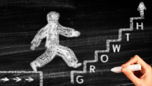 chalk drawing of a person going up stairs labeled "growth"