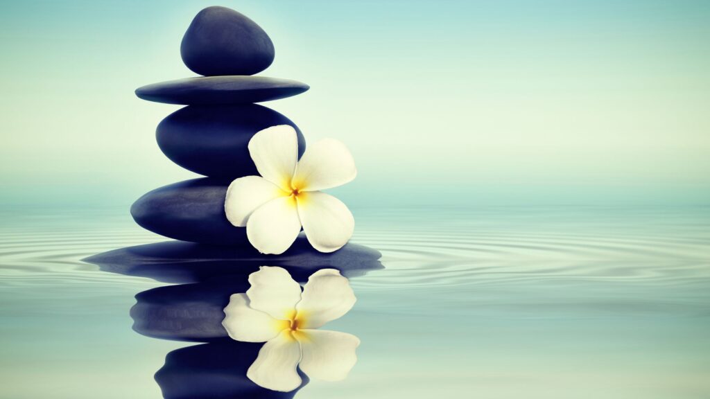 inner peace stacked rocks with flower and reflection